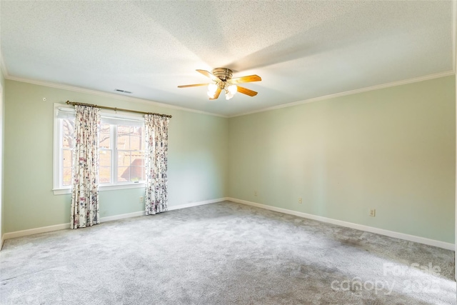 carpeted spare room with a textured ceiling, crown molding, and ceiling fan