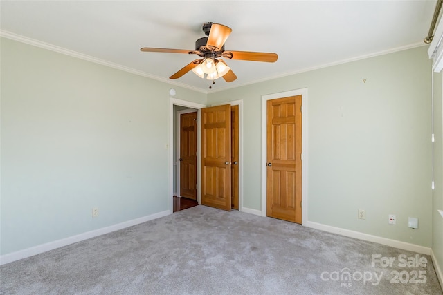 unfurnished bedroom with ornamental molding, light colored carpet, and ceiling fan