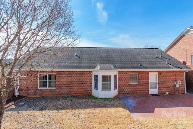 rear view of house with a patio area and a lawn