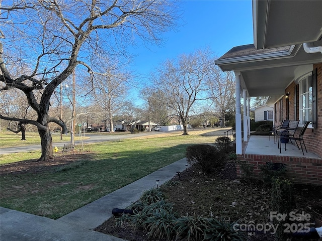 view of yard with covered porch