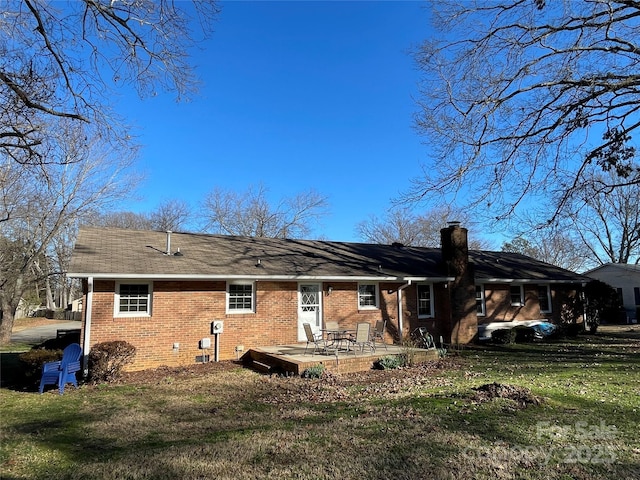 rear view of property with a yard and a patio area