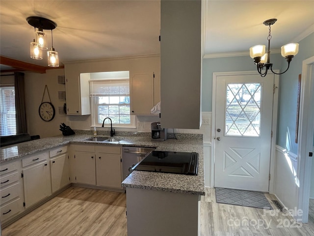 kitchen with hanging light fixtures, sink, white cabinets, and kitchen peninsula