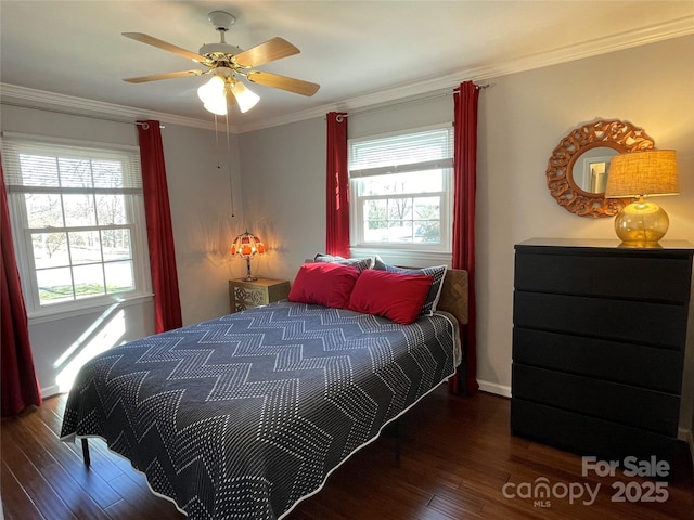 bedroom with dark hardwood / wood-style floors, multiple windows, ceiling fan, and ornamental molding