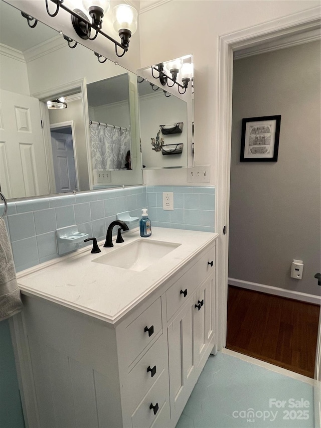 bathroom featuring tasteful backsplash, crown molding, wood-type flooring, and vanity