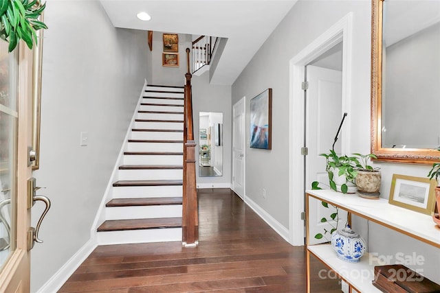 entrance foyer featuring stairway, baseboards, dark wood-type flooring, and recessed lighting