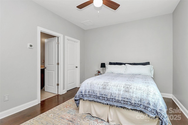 bedroom featuring ceiling fan, baseboards, and dark wood-type flooring