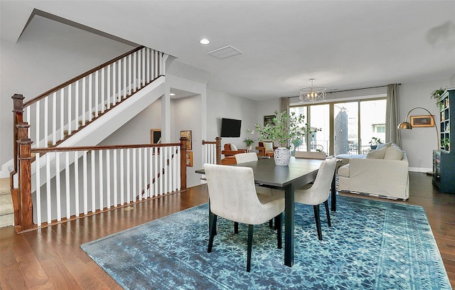 dining room featuring baseboards, dark wood-type flooring, an inviting chandelier, stairs, and recessed lighting