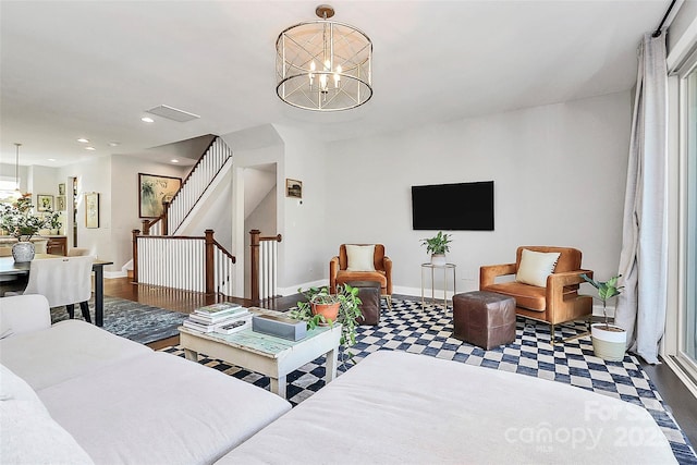 living area featuring baseboards, visible vents, stairway, a chandelier, and recessed lighting