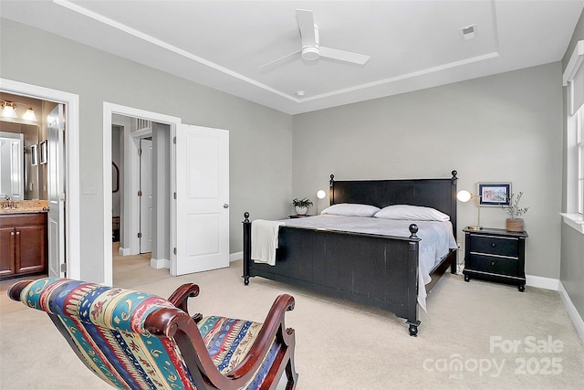 bedroom featuring baseboards, visible vents, ensuite bathroom, and light colored carpet