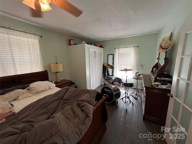 bedroom featuring a closet, dark wood finished floors, and ceiling fan