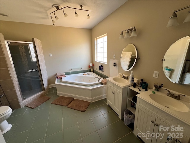 full bath featuring two vanities, tile patterned flooring, a sink, and a stall shower