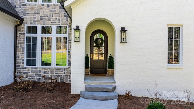 entrance to property featuring stone siding