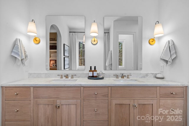 bathroom with double vanity and a sink