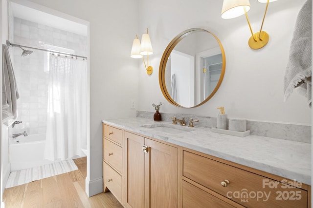 full bathroom with shower / bathtub combination with curtain, wood finished floors, and vanity