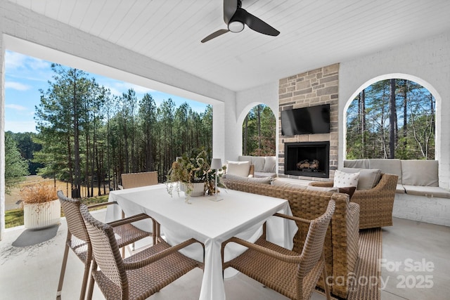 view of patio / terrace featuring an outdoor living space with a fireplace and outdoor dining area