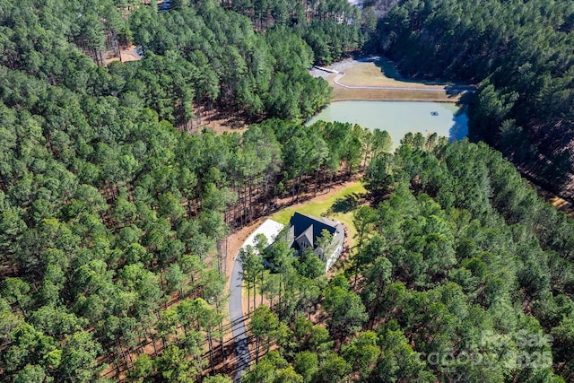 bird's eye view with a water view and a wooded view