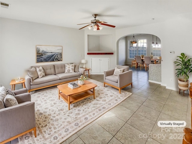 tiled living room featuring ceiling fan