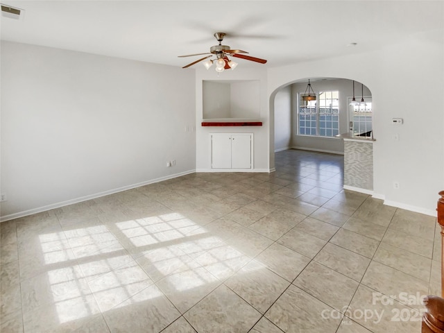 unfurnished living room featuring ceiling fan and light tile patterned floors