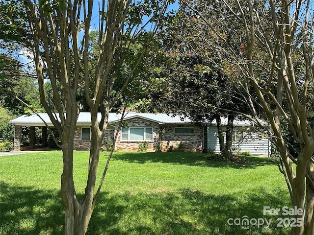 ranch-style home featuring a carport and a front yard