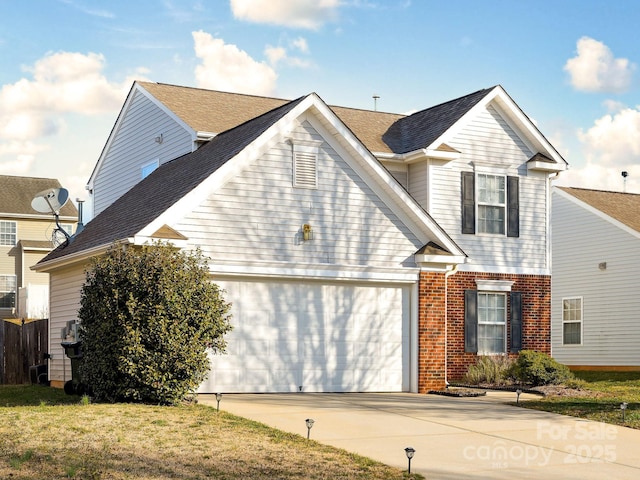 view of front property featuring a front lawn and a garage