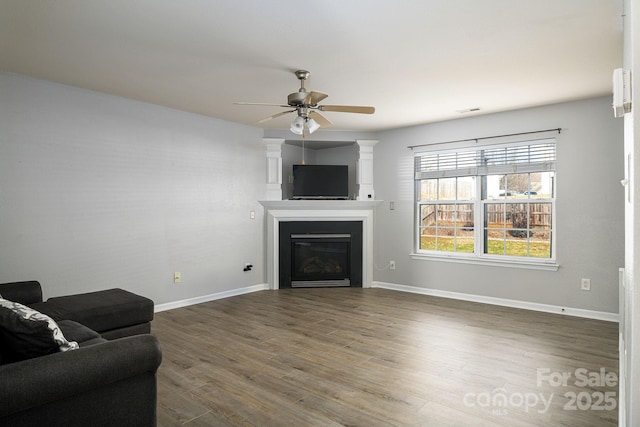 living room featuring hardwood / wood-style flooring and ceiling fan