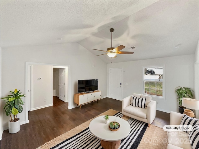 living area with lofted ceiling, a ceiling fan, dark wood finished floors, and a textured ceiling