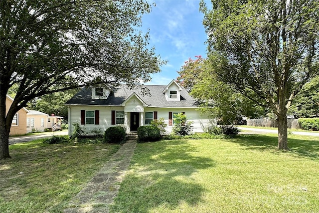 cape cod-style house featuring a front lawn