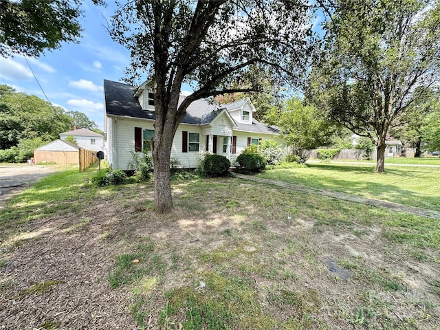 cape cod home with a front yard