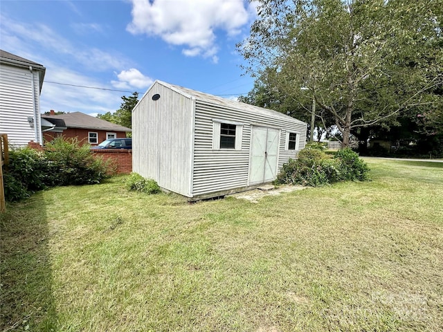 view of outbuilding featuring a lawn