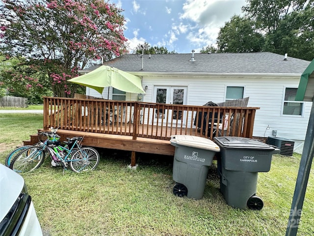 back of house with a yard, a wooden deck, and cooling unit