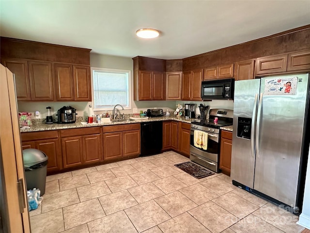 kitchen featuring light tile patterned floors, sink, light stone countertops, and black appliances