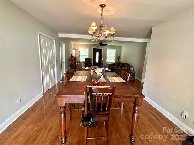 dining area featuring a chandelier and wood-type flooring