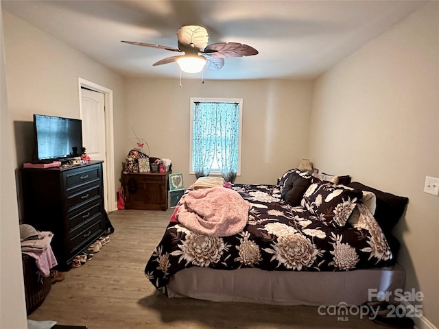 bedroom with ceiling fan and light hardwood / wood-style floors