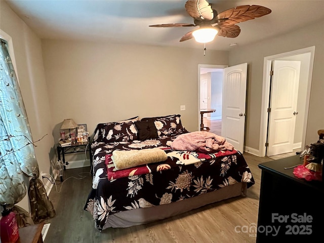 bedroom featuring hardwood / wood-style floors and ceiling fan