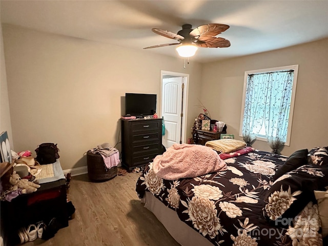 bedroom with hardwood / wood-style flooring and ceiling fan