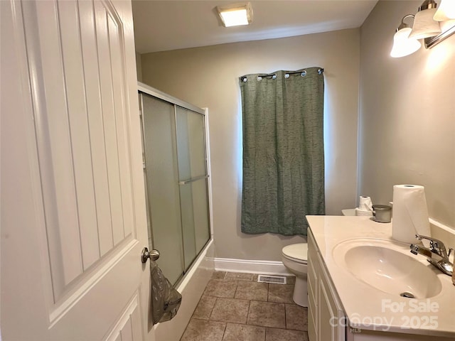 full bathroom featuring toilet, vanity, and enclosed tub / shower combo