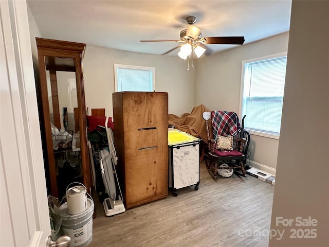 interior space with ceiling fan