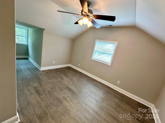 bonus room with vaulted ceiling, dark hardwood / wood-style floors, and ceiling fan