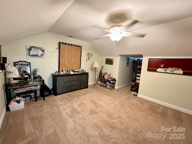 interior space with vaulted ceiling, ceiling fan, and light colored carpet