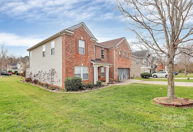 view of side of home featuring a yard, driveway, brick siding, and an attached garage