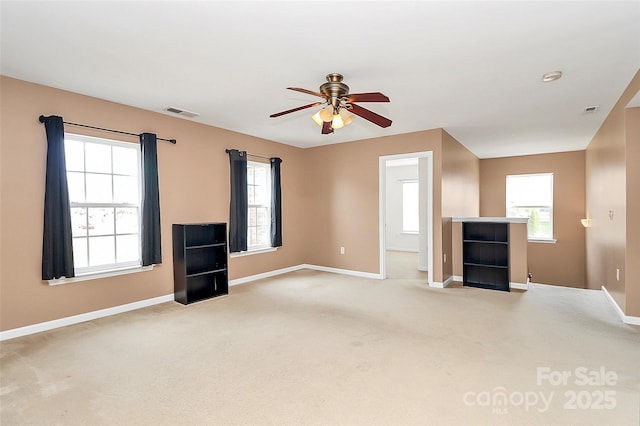 unfurnished living room featuring light carpet, baseboards, visible vents, and a ceiling fan