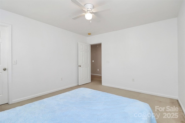 bedroom with a ceiling fan, light carpet, and baseboards