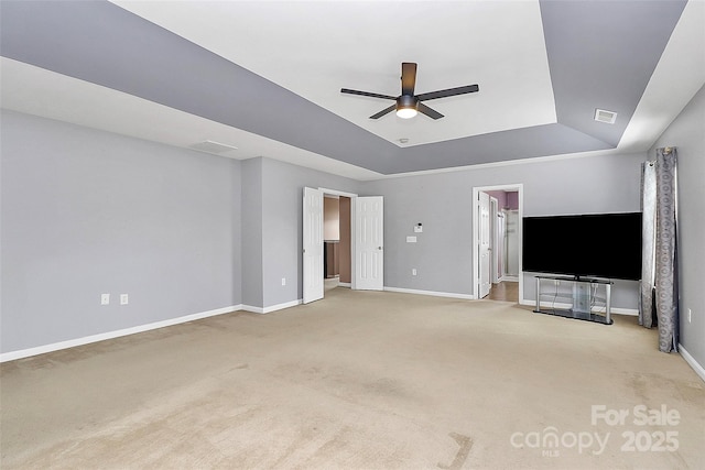 unfurnished living room with visible vents, a raised ceiling, a ceiling fan, and carpet flooring