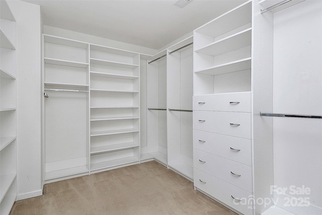 spacious closet with light carpet and visible vents