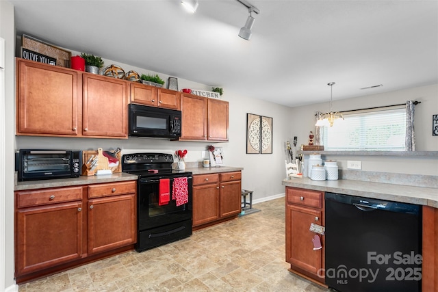 kitchen featuring a toaster, brown cabinetry, light countertops, black appliances, and pendant lighting