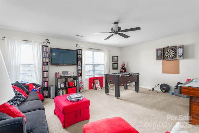 living room with light carpet, ceiling fan, visible vents, and baseboards