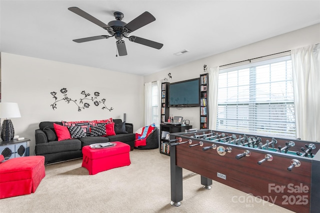 playroom with carpet floors, visible vents, and a ceiling fan