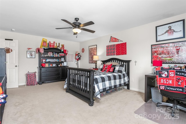 carpeted bedroom with baseboards and a ceiling fan