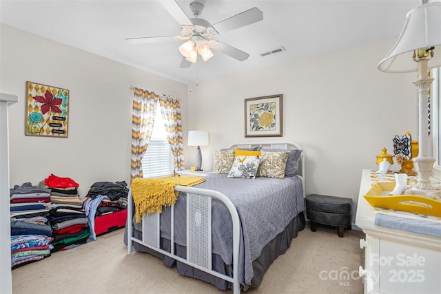 bedroom with carpet, visible vents, and a ceiling fan