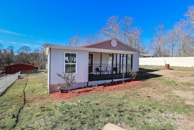 bungalow-style home with a porch, a front yard, and fence private yard